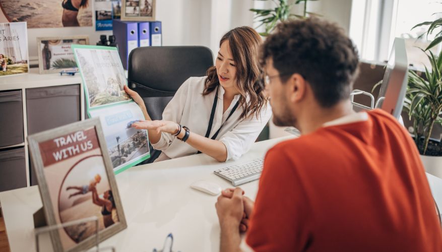 travel agent showing client trip itineraries